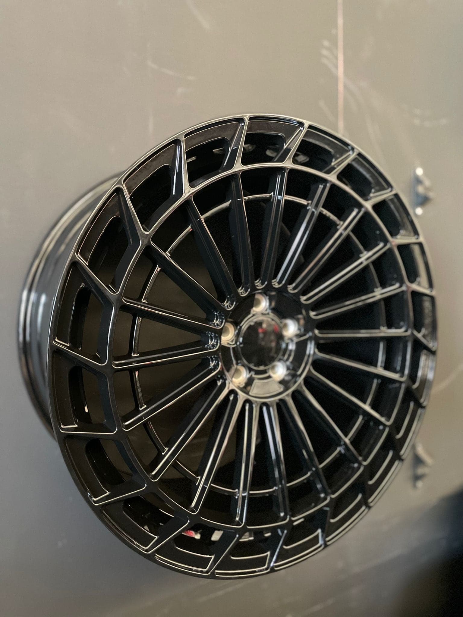 Close-up van een gepolijste lichtmetalen velg met dunne spaken